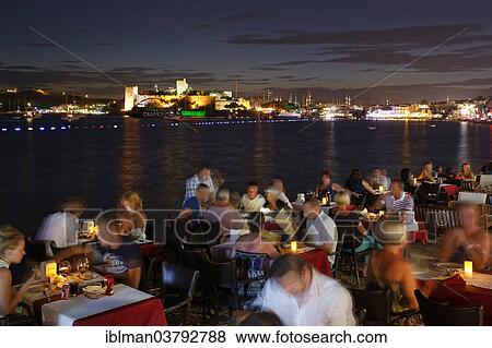 "Restaurant in Kumbahce bay with Bodrum Castle, Bodrum, Mugla Province, Aegean Region, Turkey, Asia" View Large Photo Image Stock Photo - "Restaurant in Kumbahce bay with Bodrum Castle, Bodrum, Mugla Province, Aegean Region, Turkey, Asia". Fotosearch