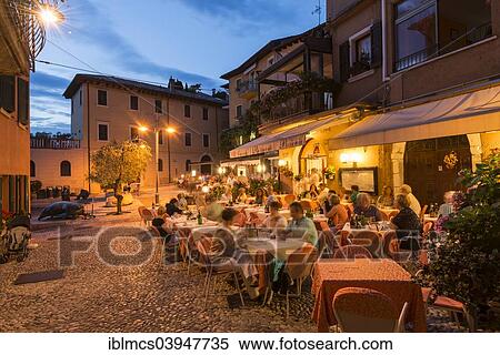 "Restaurant in the evening, Malcesine, Verona province, Veneto, Italy, Europe" View Large Photo Image Stock Photography - "Restaurant in the evening, Malcesine, Verona province, Veneto, Italy, Europe". Fotosearch