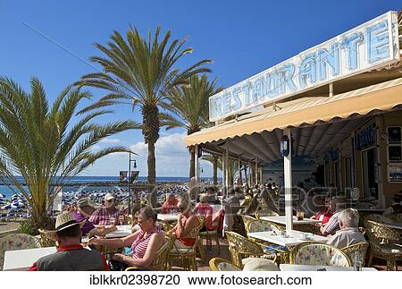 Stock Image - "Restaurant on the beach promenade of Playa de las Vistas, Los Cristianos, Tenerife, Spain, Europe". Fotosearch