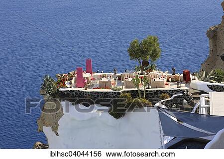 "Restaurant terrace on cliffs, sea view, Santorini, Oia, Cyclades, Aegean Sea, Greece, Europe" View Large Photo Image Stock Photograph - "Restaurant terrace on cliffs, sea view, Santorini, Oia, Cyclades, Aegean Sea, Greece, Europe". Fotosearch