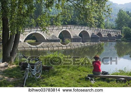 "Restored bridge over the Saale River, cyclist sitting on the river bank, Jena-Burgau, Jena, Thuringia, Germany, Europe" View Large Photo Image Picture - "Restored bridge over the Saale River, cyclist sitting on the river bank, Jena-Burgau, Jena, Thuringia, Germany, Europe". Fotosearch