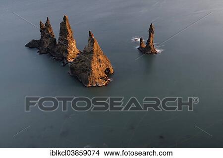 "Reynisdrangar basalt sea stacks and traces of flying birds, Vik, Iceland, Europe" View Large Photo Image Picture - "Reynisdrangar basalt sea stacks and traces of flying birds, Vik, Iceland, Europe". Fotosearch