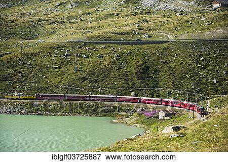 "Rhaetian Railway, Bernina Express at Lago Bianco lake, Bernina Pass, Pontresina, Canton of Graubunden, Switzerland, Europe" View Large Photo Image Stock Photo - "Rhaetian Railway, Bernina Express at Lago Bianco lake, Bernina Pass, Pontresina, Canton of Graubunden, Switzerland, Europe". Fotosearch