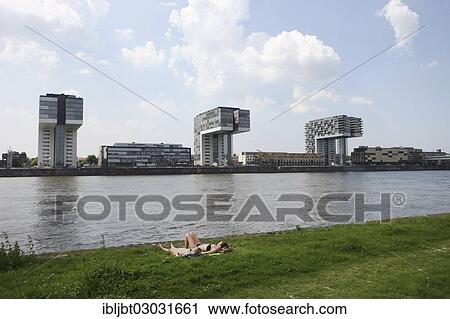 "Rheinauhafen harbour from the Poller Wiesen floodplains, two women sunbathing on the banks of the Rhine, Cologne, Rhineland, North Rhine-Westphalia, Germany, Europe" View Large Photo Image Stock Image - "Rheinauhafen harbour from the Poller Wiesen floodplains, two women sunbathing on the banks of the Rhine, Cologne, Rhineland, North Rhine-Westphalia, Germany, Europe". Fotosearch