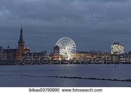 "Rheinfront promenade with Schlossturm tower, Church of St. Lambertus and an illuminated ferris wheel, historic town centre, Dusseldorf, North Rhine-Westphalia, Germany, Europe" View Large Photo Image Stock Image - "Rheinfront promenade with Schlossturm tower, Church of St. Lambertus and an illuminated ferris wheel, historic town centre, Dusseldorf, North Rhine-Westphalia, Germany, Europe". Fotosearch