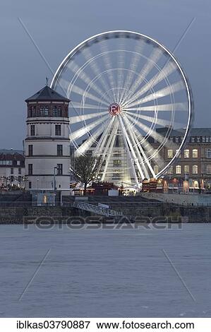 Stock Photo - "Rheinfront promenade with Schlossturm tower and an illuminated ferris wheel, historic town centre, Dusseldorf, North Rhine-Westphalia, Germany, Europe". Fotosearch