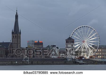 "Rheinfront promenade with Schlossturm tower, Church of St. Lambertus and an illuminated ferris wheel, historic town centre, Dusseldorf, North Rhine-Westphalia, Germany, Europe" View Large Photo Image Stock Photography - "Rheinfront promenade with Schlossturm tower, Church of St. Lambertus and an illuminated ferris wheel, historic town centre, Dusseldorf, North Rhine-Westphalia, Germany, Europe". Fotosearch