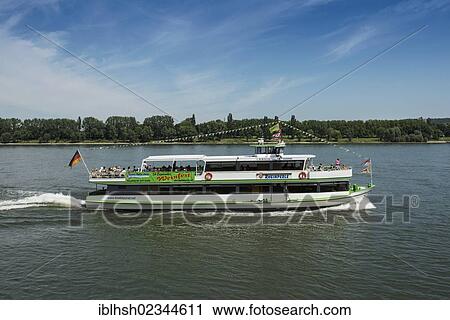 "Rheinperle, a crowded excursion boat of the Koelntourist Personenschiffahrt am Dom GmbH shipping company traveling on the Rhine river near Cologne, North Rhine-Westphalia, Germany, Europe" View Large Photo Image Stock Image - "Rheinperle, a crowded excursion boat of the Koelntourist Personenschiffahrt am Dom GmbH shipping company traveling on the Rhine river near Cologne, North Rhine-Westphalia, Germany, Europe". Fotosearch