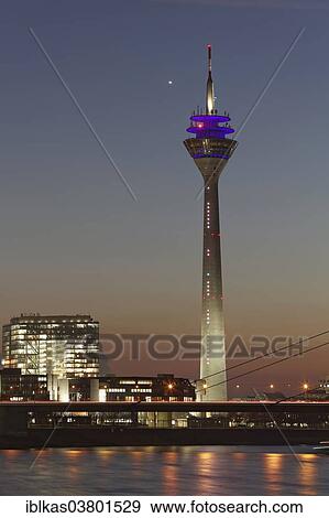 Stock Photo - "Rheinturm tower and """"Stadttor"""" high-rise building at twilight, Dusseldorf, North Rhine-Westphalia, Germany, Europe". Fotosearch