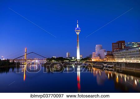 Stock Photo - "Rhineturm, Rhine Tower and the Gehry buildings or Neuer Zollhof, Medienhafen, Media Harbour, Duesseldorf, North Rhine-Westphalia, Germany, Europe". Fotosearch