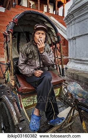 "Rickshaw driver takes a rest, Kathmandu, Kathmandu District, Bagmati Zone, Nepal, Asia" View Large Photo Image Stock Image - "Rickshaw driver takes a rest, Kathmandu, Kathmandu District, Bagmati Zone, Nepal, Asia". Fotosearch