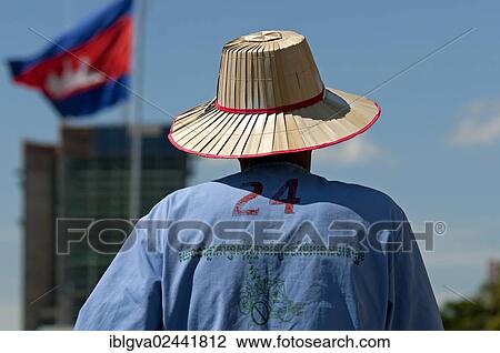Stock Image - "Rickshaw driver wearing a straw hat, Phnom Penh, Cambodia, Southeast Asia, Asia". Fotosearch
