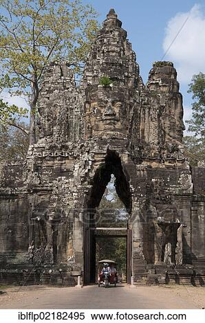 Stock Photography - "Rickshaw going through gate tower at Khmer temple, South Gate, Angkor Thom, Siem Reap, Cambodia, Southeast Asia, Asia". Fotosearch