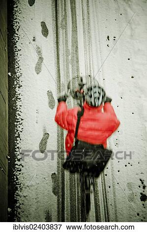 Stock Photo - Riding a bike in the snow. Fotosearch