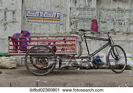 "Rikshaw kuli sleeping in the back of his rickshaw, Kolkata, India, Asia" View Large Photo Image Stock Image - "Rikshaw kuli sleeping in the back of his rickshaw, Kolkata, India, Asia". Fotosearch
