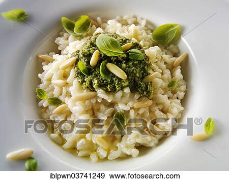 Stock Photo - Risotto with pesto sauce and pine nuts. Fotosearch
