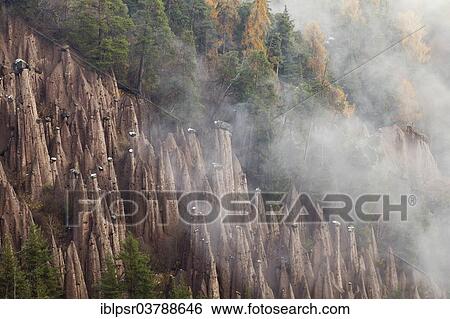 "Rittner Erdpyramiden fairy chimneys of Lengmoos in rising mist, Bolzano, South Tyrol, Italy, Europe" View Large Photo Image Stock Photograph - "Rittner Erdpyramiden fairy chimneys of Lengmoos in rising mist, Bolzano, South Tyrol, Italy, Europe". Fotosearch
