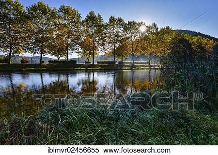 Stock Photography - "River in the morning with sunrays, Stubenbergsee lake, Styria, Austria, Europe". Fotosearch