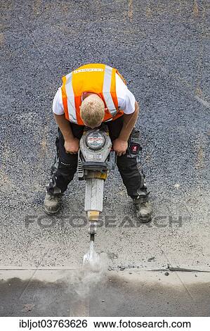 "Road construction worker operating a pneumatic drill, tarmac laying works at a road construction site, Essen, North Rhine-Westphalia, Germany, Europe" View Large Photo Image Stock Photograph - "Road construction worker operating a pneumatic drill, tarmac laying works at a road construction site, Essen, North Rhine-Westphalia, Germany, Europe". Fotosearch