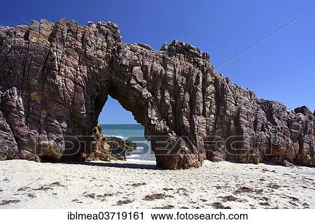 Stock Image - "Rock arch on the beach, Jericoacoara, Ceara, Brazil, South America". Fotosearch