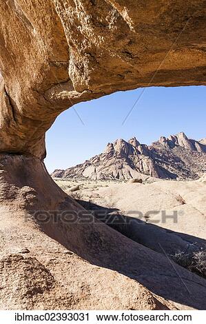 "Rock arch, Pontok Mountains at the back, near the Spitzkoppe granite peaks, Damaraland, Namibia, Africa" View Large Photo Image Stock Image - "Rock arch, Pontok Mountains at the back, near the Spitzkoppe granite peaks, Damaraland, Namibia, Africa". Fotosearch