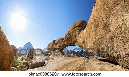 Stock Photo - "Rock bridge, behind the Pontok Mountains and the Spitzkoppe, Damaraland, Namibia, Africa". Fotosearch