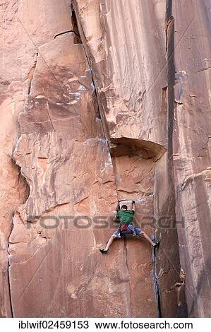 "Rock climber climbing a rock wall, near Moab, Utah, USA" View Large Photo Image Stock Image - "Rock climber climbing a rock wall, near Moab, Utah, USA". Fotosearch