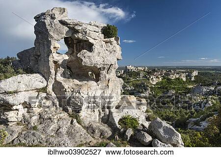 Stock Photo - "Rock formation in the Regional Natural Park of the Alpilles, Les Baux-de-Provence with castle ruins at the back, Les Baux-de-Provence, Provence-Alpes-Cote d'Azur, France, Europe". Fotosearch