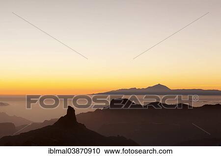 Stock Image - "Rock formation of Roque Bentayga in front of Tenerife with Mount Teide, Gran Canaria, Canary Islands, Spain, Europe". Fotosearch