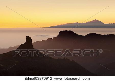 "Rock formation of Roque Bentayga in front of Tenerife with Mount Teide, Gran Canaria, Canary Islands, Spain, Europe" View Large Photo Image Stock Image - "Rock formation of Roque Bentayga in front of Tenerife with Mount Teide, Gran Canaria, Canary Islands, Spain, Europe". Fotosearch