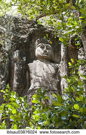 "Rock relief, Buddha figure behind green leaves, raised hand, protection gesture, Mahayana Buddhism, Dowa Rock Temple near Bandarawela, Uva Province, Sri Lanka, Asia" View Large Photo Image Picture - "Rock relief, Buddha figure behind green leaves, raised hand, protection gesture, Mahayana Buddhism, Dowa Rock Temple near Bandarawela, Uva Province, Sri Lanka, Asia". Fotosearch