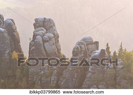 "Rocks in the Elbe Sandstone Mountains in the morning mist in autumn, Saxon Switzerland, Bad Schandau, Saxony, Germany, Europe" View Large Photo Image Stock Photography - "Rocks in the Elbe Sandstone Mountains in the morning mist in autumn, Saxon Switzerland, Bad Schandau, Saxony, Germany, Europe". Fotosearch