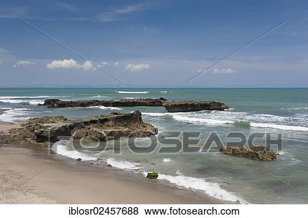 Stock Photo - "Rocks in the surf, Echo Beach, surf beach Batubelig, Seminyak, Bali, Indonesia, Asia". Fotosearch