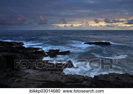 Stock Image - "Rocks on the coast of the Atlantic Ocean in the evening, Northern Highlands, Highlands, Sutherland County, Highland, Scotland, United Kingdom, Europe". Fotosearch