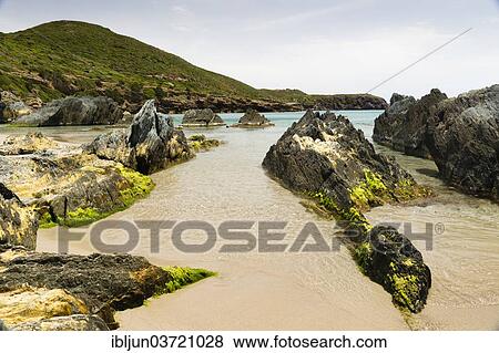 Stock Photo - "Rocks overgrown with algae in the Spiaggia di Planusartu bay, Masua, Iglesiente, Sardinia, Italy, Europe". Fotosearch