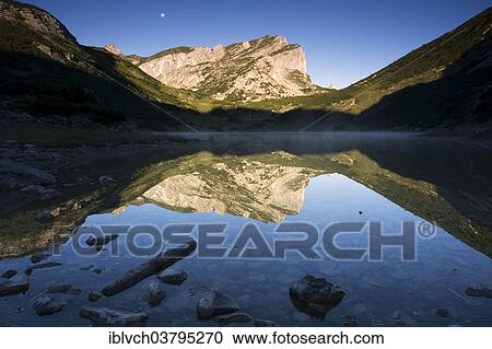 Stock Image - "Rofanspitze reflected in Zireiner See, Rofan Mountains, Tyrol, Austria, Europe". Fotosearch