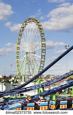 "Roller coaster and Ferris wheel, Cannstatter Wasen, Stuttgart Beer Festival, spring festival, fairground, Stuttgart, Baden-Wuerttemberg, Germany, Europe" View Large Photo Image Stock Photography - "Roller coaster and Ferris wheel, Cannstatter Wasen, Stuttgart Beer Festival, spring festival, fairground, Stuttgart, Baden-Wuerttemberg, Germany, Europe". Fotosearch