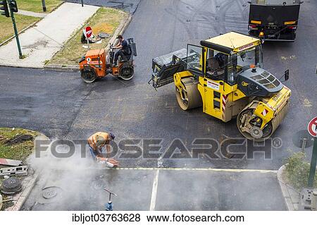 Stock Photo - "Roller compactors, tarmac laying works at a large inner-city road construction site, Essen, North Rhine-Westphalia, Germany, Europe". Fotosearch