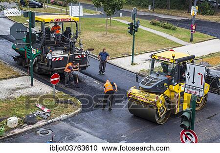 "Rolling machine and an asphalt spreader during asphalt work on a large urban road construction site, Essen, North Rhine-Westphalia, Germany, Europe" View Large Photo Image Stock Image - "Rolling machine and an asphalt spreader during asphalt work on a large urban road construction site, Essen, North Rhine-Westphalia, Germany, Europe". Fotosearch