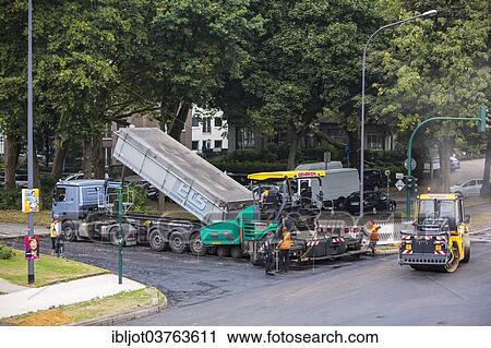 "Rolling machine and an asphalt spreader during asphalt work on a large urban road construction site, Essen, North Rhine-Westphalia, Germany, Europe" View Large Photo Image Stock Image - "Rolling machine and an asphalt spreader during asphalt work on a large urban road construction site, Essen, North Rhine-Westphalia, Germany, Europe". Fotosearch