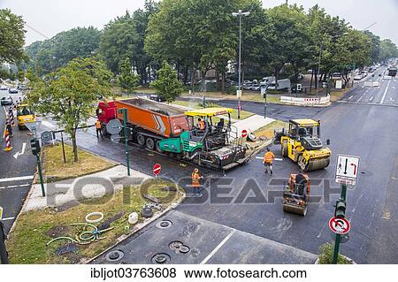 "Rolling machines and an asphalt spreader during asphalt work on a large urban road construction site, Essen, North Rhine-Westphalia, Germany, Europe" View Large Photo Image Stock Photo - "Rolling machines and an asphalt spreader during asphalt work on a large urban road construction site, Essen, North Rhine-Westphalia, Germany, Europe". Fotosearch