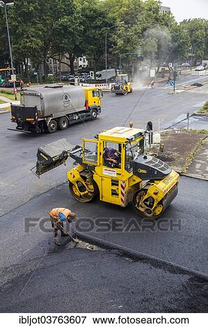 Stock Photo - "Rolling machines during asphalt work on a large urban road construction site, Essen, North Rhine-Westphalia, Germany, Europe". Fotosearch