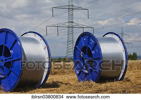 "Rolls of conductive cable waiting to be loaded after work on a high-voltage transmission mast, Monchenholzhausen, Thuringia, Germany, Europe" View Large Photo Image Picture - "Rolls of conductive cable waiting to be loaded after work on a high-voltage transmission mast, Monchenholzhausen, Thuringia, Germany, Europe". Fotosearch