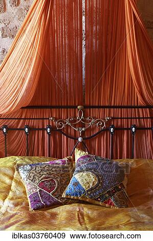 "Romantic metal bed with canopy and two oriental silk cushions, Nikos Takis Fashion Hotel, Rhodes, Rhodes island, Dodecanese, Greece, Europe" View Large Photo Image Stock Photo - "Romantic metal bed with canopy and two oriental silk cushions, Nikos Takis Fashion Hotel, Rhodes, Rhodes island, Dodecanese, Greece, Europe". Fotosearch