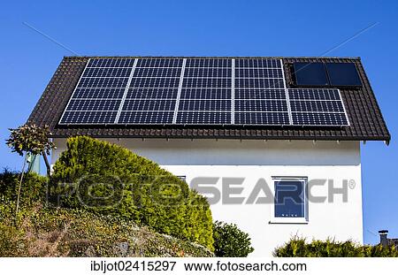 Roof of a residential house with solar panels to generate electricity and solar thermal panels for hot water View Large Photo Image Stock Photo - Roof of a residential house with solar panels to generate electricity and solar thermal panels for hot water. Fotosearch