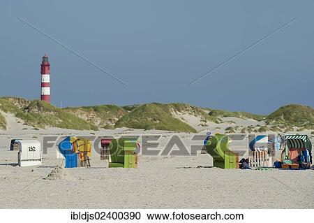 "Roofed wicker beach chairs and lighthouse at Nebel, Amrum, North Frisian Islands, Schleswig-Holstein, Germany, Europe" View Large Photo Image Stock Image - "Roofed wicker beach chairs and lighthouse at Nebel, Amrum, North Frisian Islands, Schleswig-Holstein, Germany, Europe". Fotosearch
