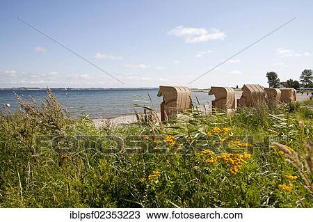 Stock Image - "Roofed wicker beach chairs and the Baltic Sea near Langballigau in Schleswig-Holstein, Germany, Europe". Fotosearch