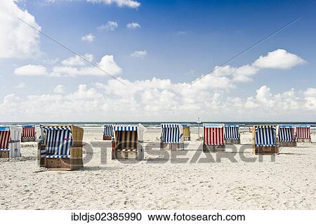 "Roofed wicker beach chairs on the beach of St. Peter-Ording, North Frisia, Schleswig-Holstein, Germany, Europe" View Large Photo Image Stock Image - "Roofed wicker beach chairs on the beach of St. Peter-Ording, North Frisia, Schleswig-Holstein, Germany, Europe". Fotosearch