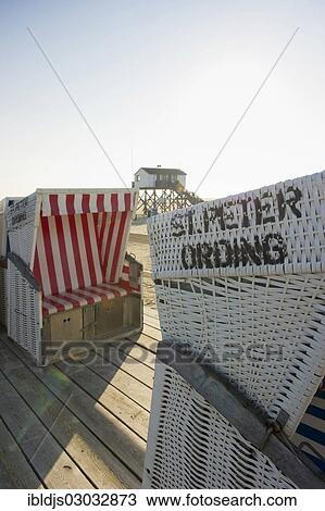 "Roofed wicker beach chairs on the beach in front of a house on stilts, St Peter-Ording, Schleswig-Holstein, Germany, Europe" View Large Photo Image Stock Image - "Roofed wicker beach chairs on the beach in front of a house on stilts, St Peter-Ording, Schleswig-Holstein, Germany, Europe". Fotosearch