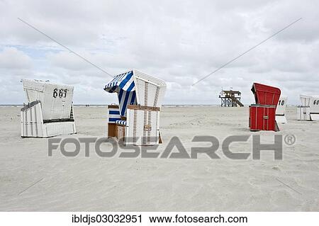 "Roofed wicker beach chairs on the beach in front of a house on stilts, St Peter-Ording, Schleswig-Holstein, Germany, Europe" View Large Photo Image Stock Image - "Roofed wicker beach chairs on the beach in front of a house on stilts, St Peter-Ording, Schleswig-Holstein, Germany, Europe". Fotosearch